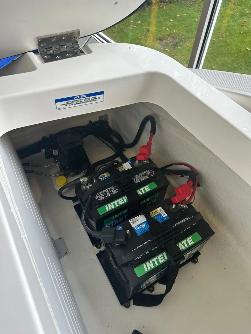 Slide: The Image of 2024 Sea Ray SPX 210 boat battery compartment with Interstate batteries. - 7