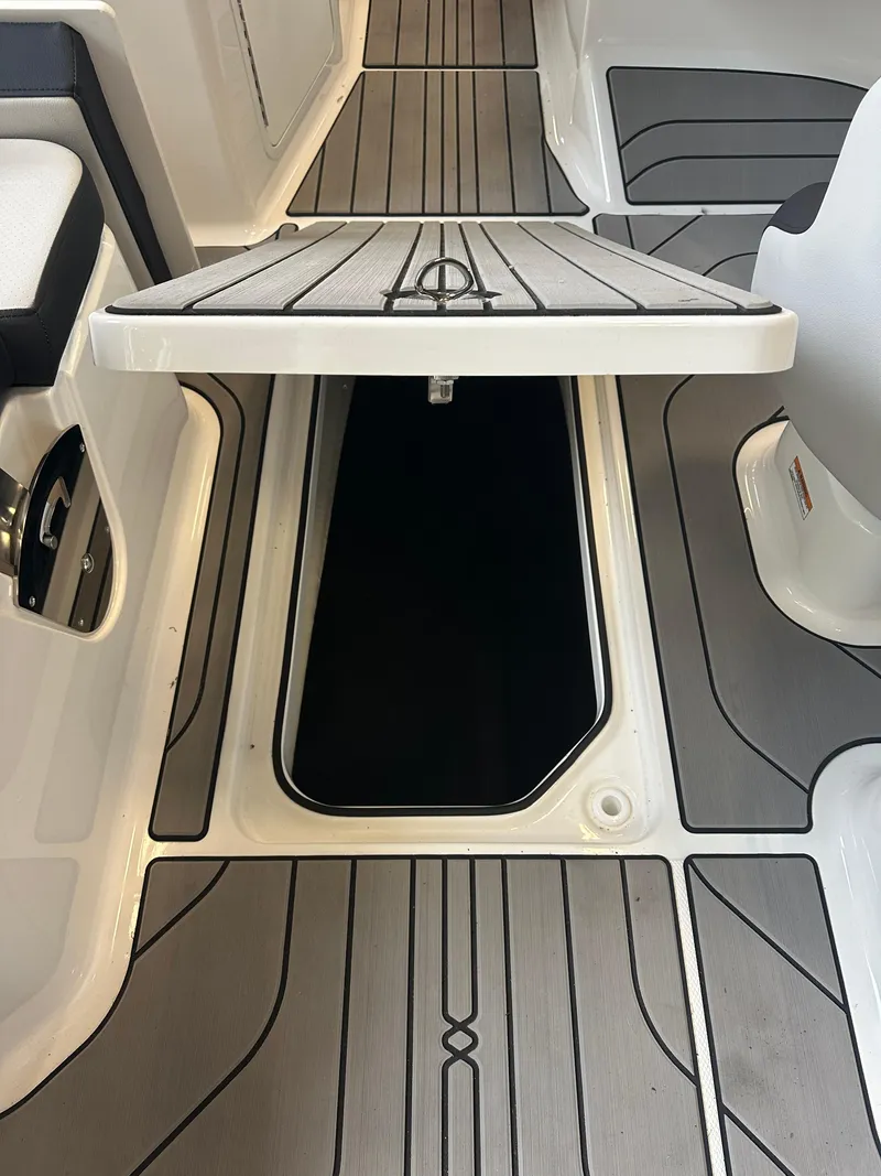 Slide: The Image of 2024 Sea Ray SPX 210 boat interior with open storage compartment. - 9