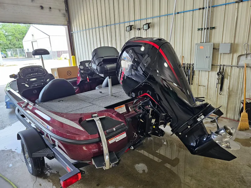 Slide: The Image of 2024 Nitro Z17 bass boat in a garage, featuring a powerful outboard motor. - 5