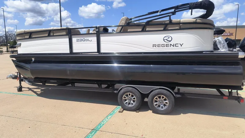 The Image of 2024 Regency 230 DL3 pontoon boat displayed at Tracker Boats dealership. - 0