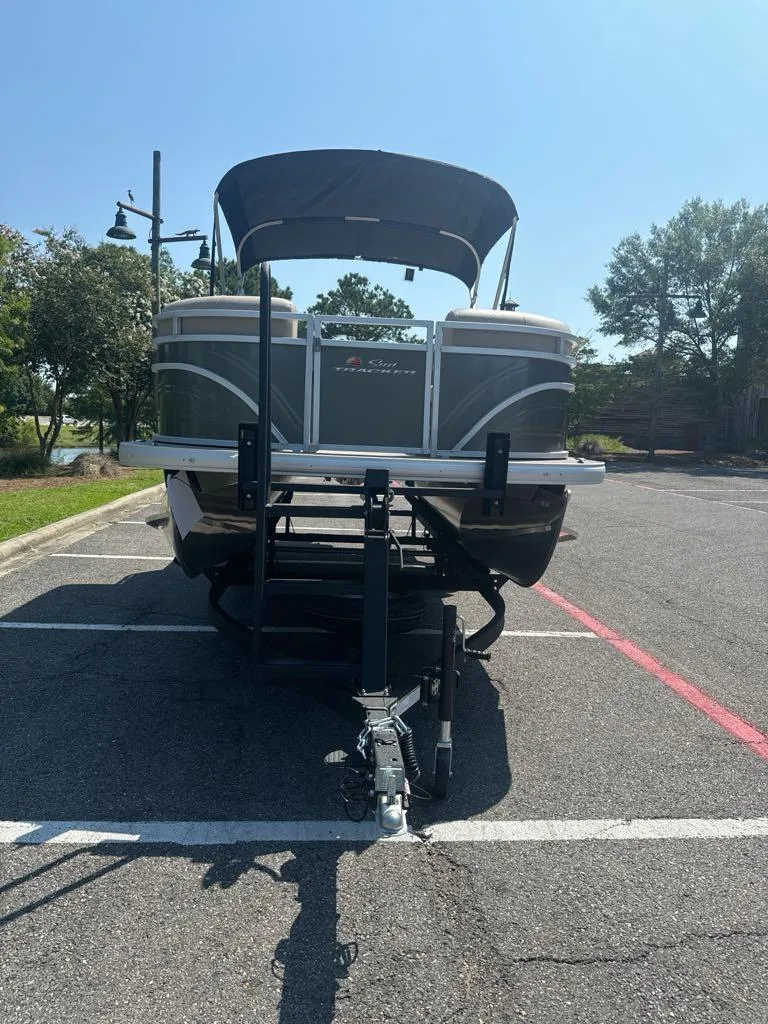 Slide: The Image of 2024 Sun Tracker Party Barge 20 DLX pontoon boat in parking lot. - 3