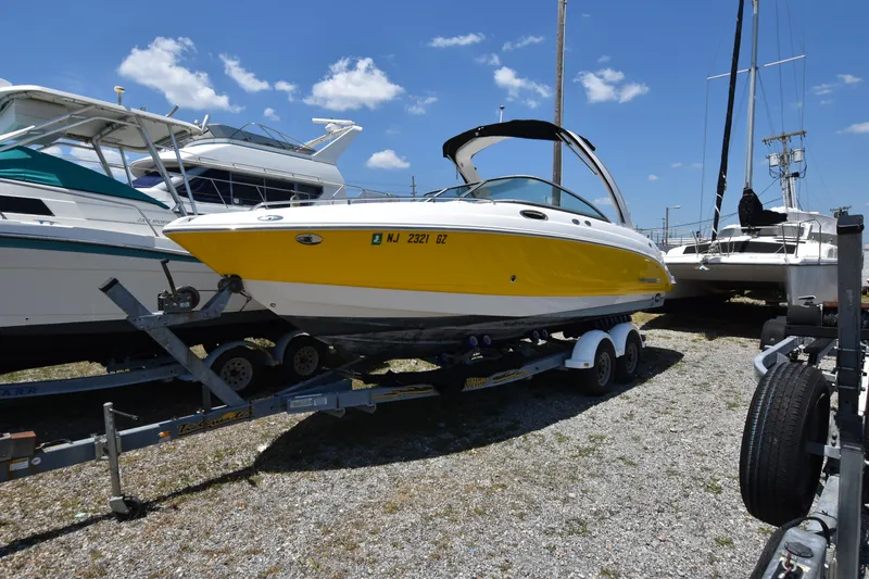 Slide: The Image of 2007 Chaparral 256 SSi boat in yellow and white on a trailer. - 1