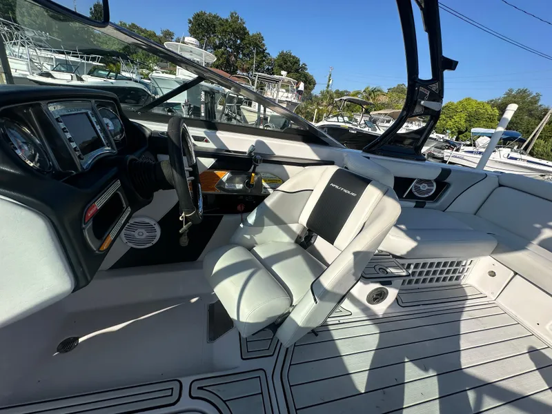 Slide: The Image of 2010 Nautique Super Air Nautique 230 boat interior with captain's chair and dashboard. - 11