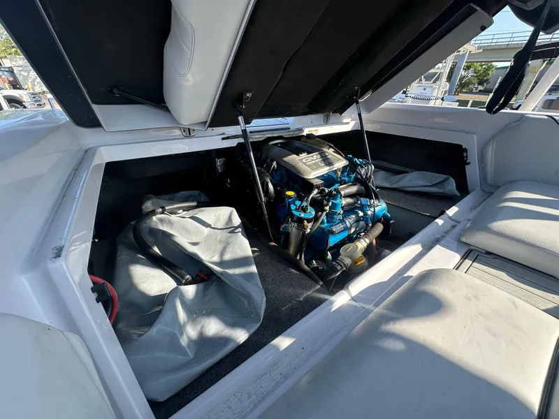 Slide: The Image of 2010 Nautique Super Air Nautique 230 engine compartment with open hatch. - 13