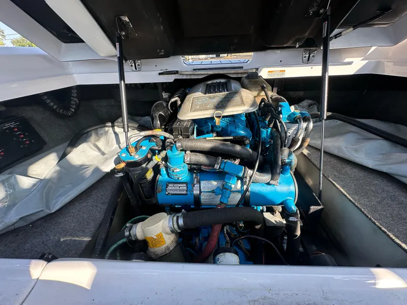 Slide: The Image of 2010 Nautique Super Air Nautique 230 engine compartment with open hatch. - 15