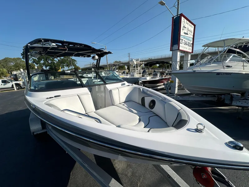 Slide: The Image of 2010 Nautique Super Air Nautique 230 boat on trailer in marina. - 5