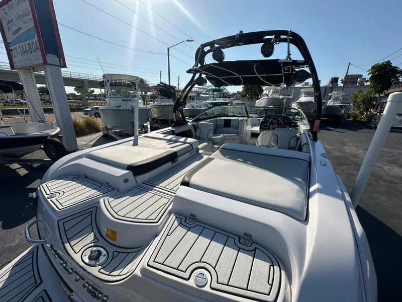 Slide: The Image of 2010 Nautique Super Air Nautique 230 boat with spacious seating and sleek design. - 7