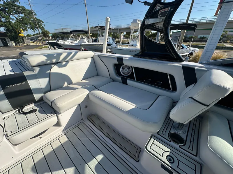 Slide: The Image of 2010 Nautique Super Air Nautique 230 interior seating and deck area. - 8