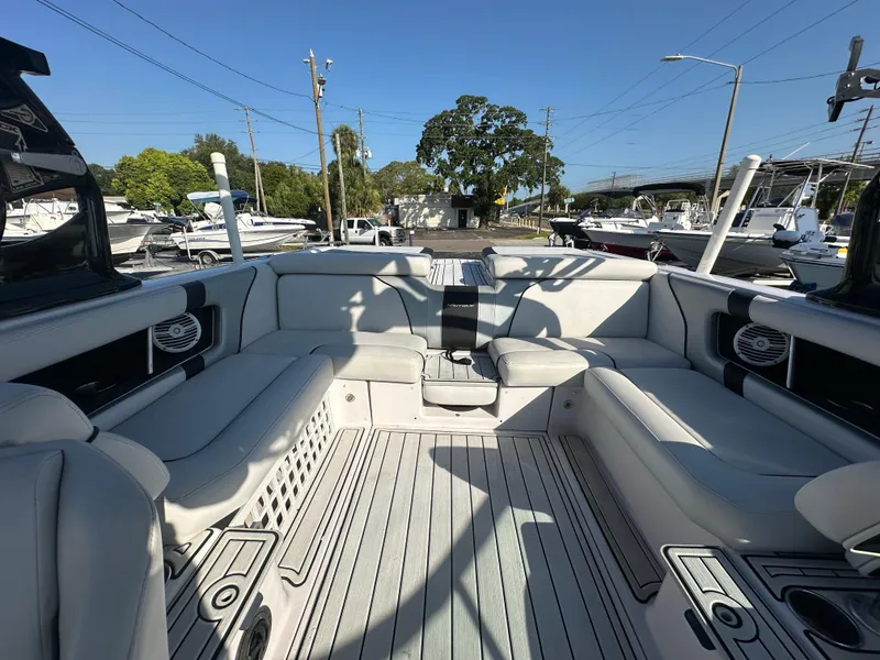 Slide: The Image of 2010 Nautique Super Air Nautique 230 boat interior with spacious seating and modern design. - 9