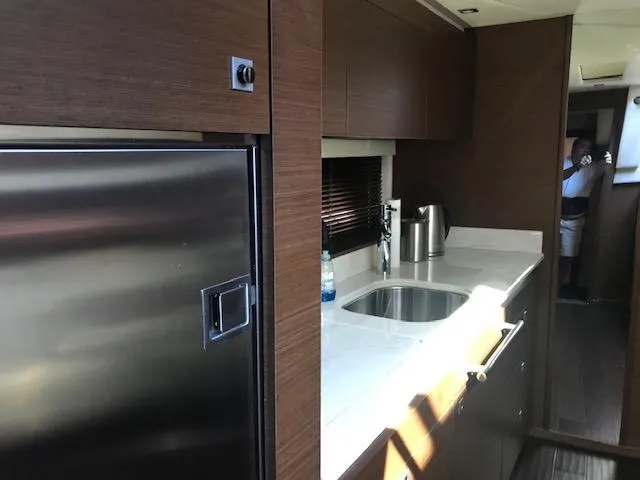 Slide: The Image of Modern kitchen area in 2013 Sea Ray 470 Sundancer yacht with stainless steel appliances. - 15