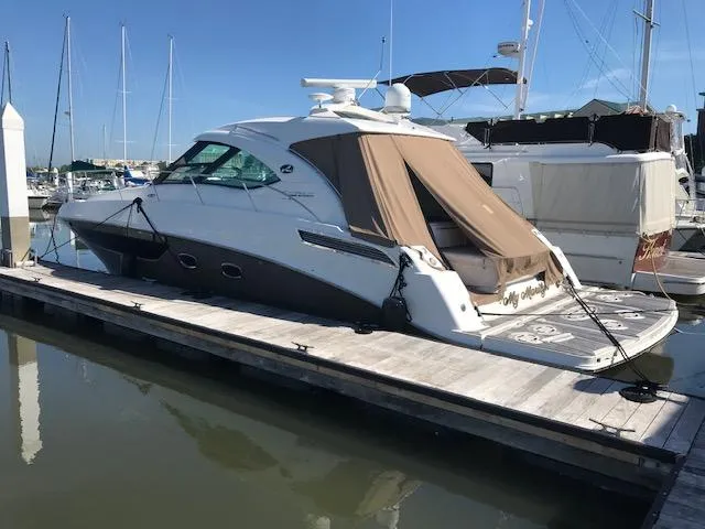 Slide: The Image of 2013 Sea Ray 470 Sundancer yacht docked at marina. - 2