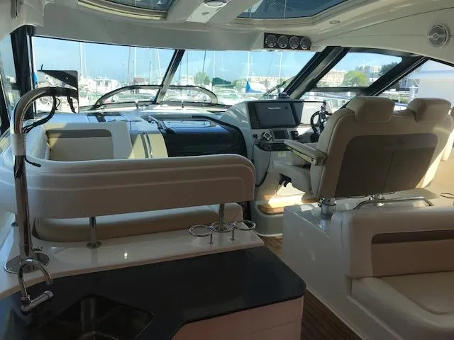 Slide: The Image of Interior of 2013 Sea Ray 470 Sundancer yacht with helm and seating area. - 5