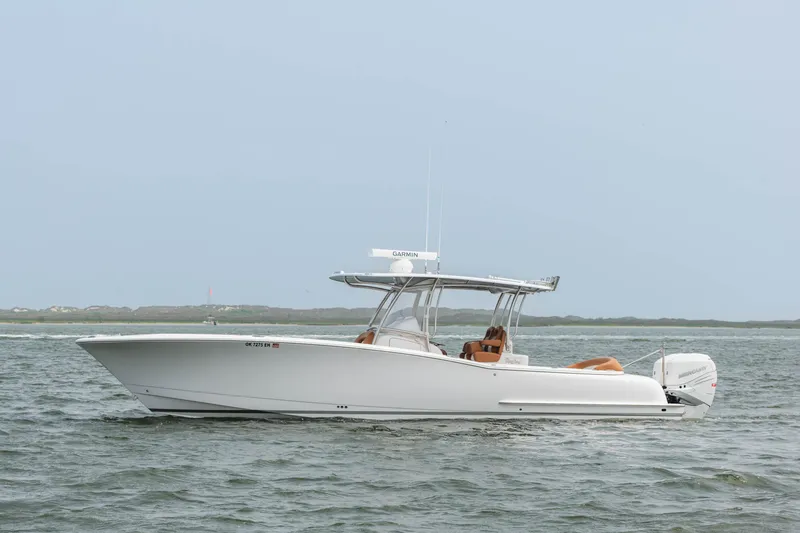 Slide: The Image of 2022 Mag Bay 33cc boat on the water with a clear sky background. - 1