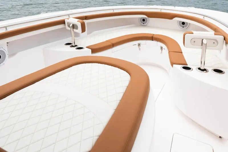 Slide: The Image of 2022 Mag Bay 33cc boat interior with tan and white cushioned seating. - 10