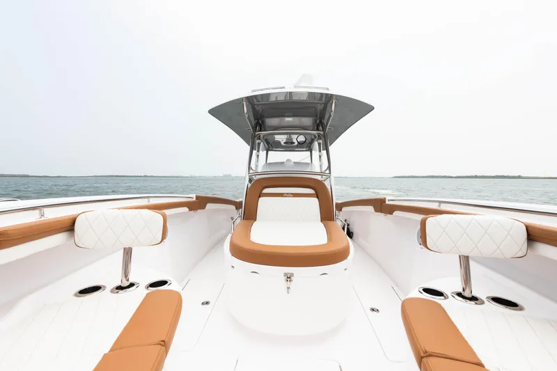 Slide: The Image of 2022 Mag Bay 33cc boat interior with tan and white seating. - 12