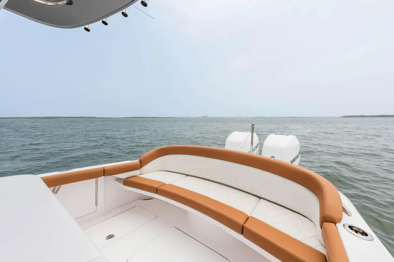 Slide: The Image of 2022 Mag Bay 33cc boat with cushioned seating and twin engines on open water. - 13