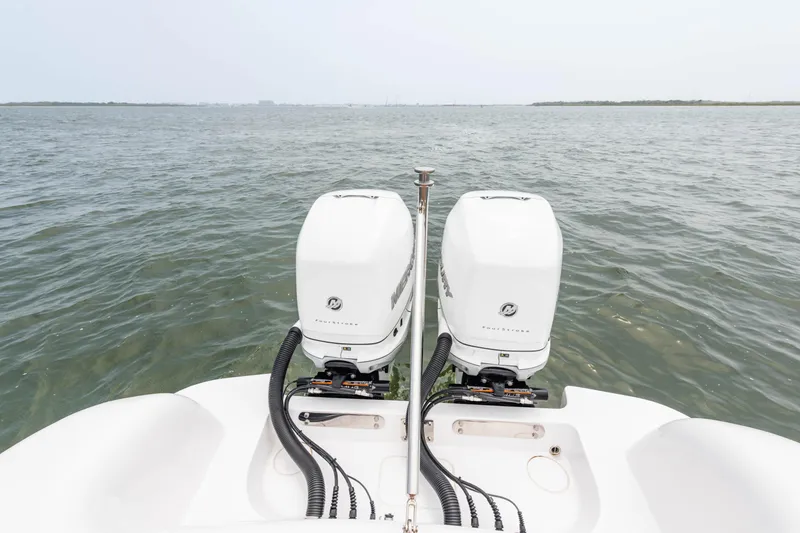 Slide: The Image of 2022 Mag Bay 33cc boat with twin outboard engines on open water. - 14