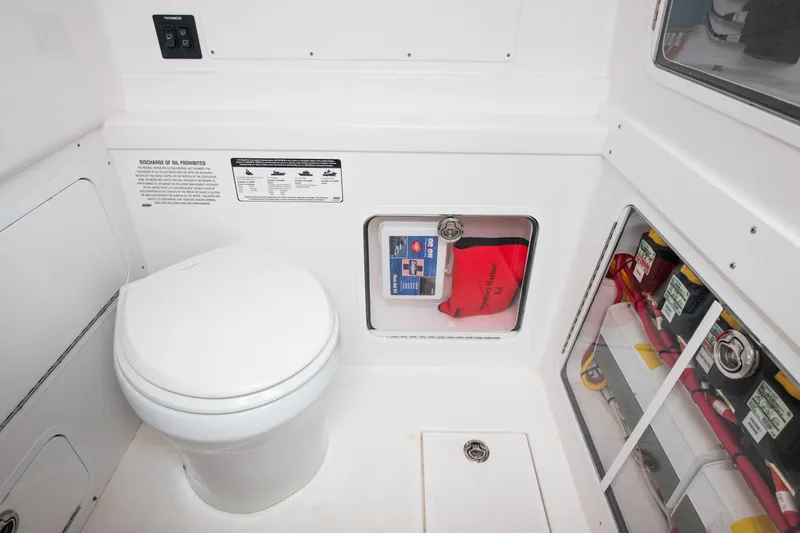 Slide: The Image of 2022 Mag Bay 33cc boat interior with toilet and storage compartments. - 17