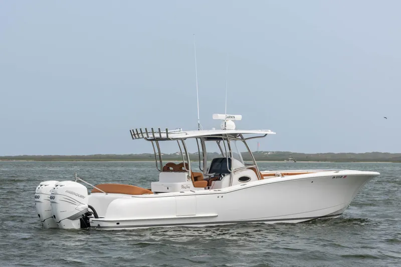Slide: The Image of 2022 Mag Bay 33cc boat on water with twin outboard engines. - 2