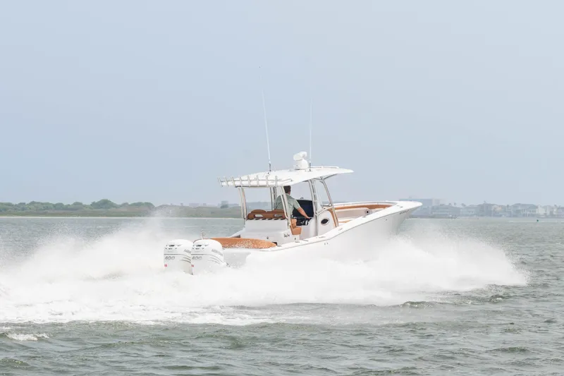 Slide: The Image of 2022 Mag Bay 33cc boat cruising on water with twin engines. - 4