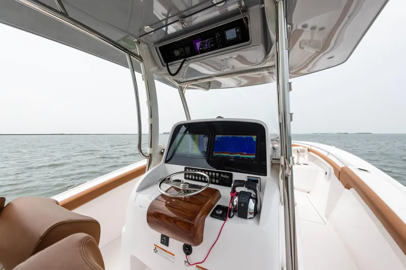 Slide: The Image of 2022 Mag Bay 33cc center console boat with advanced navigation system on open water. - 6