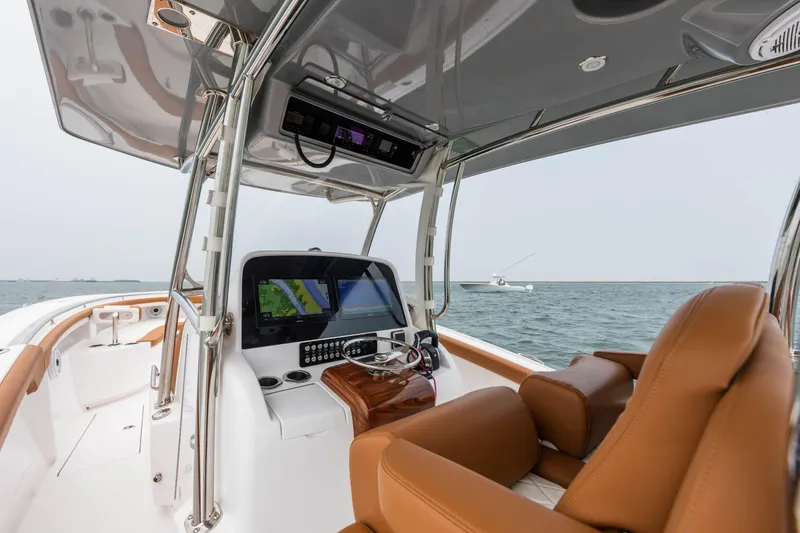 Slide: The Image of 2022 Mag Bay 33cc boat interior with advanced navigation system and leather seats. - 8