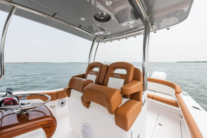 Slide: The Image of 2022 Mag Bay 33cc boat interior with luxurious seating and ocean view. - 9