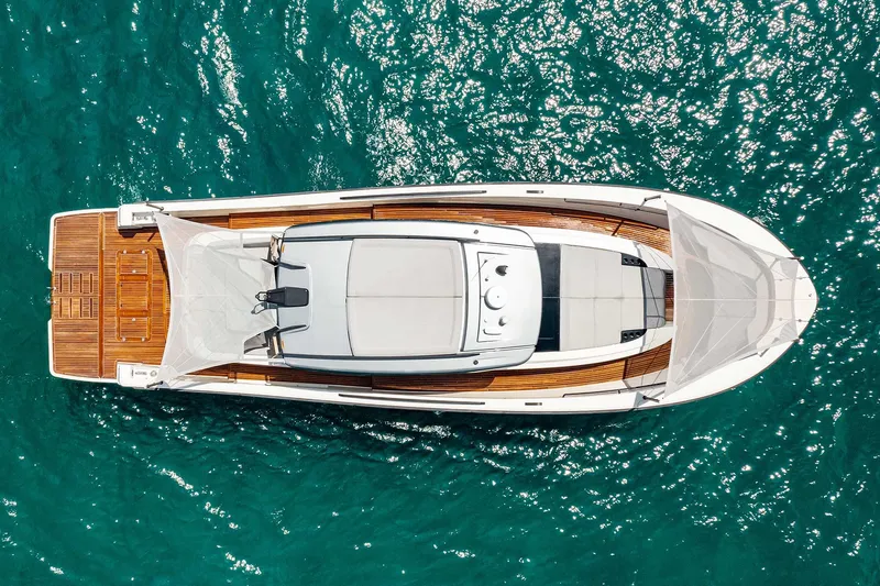 Slide: The Image of Aerial view of 2019 Bluegame BG62 yacht on turquoise water. - 1