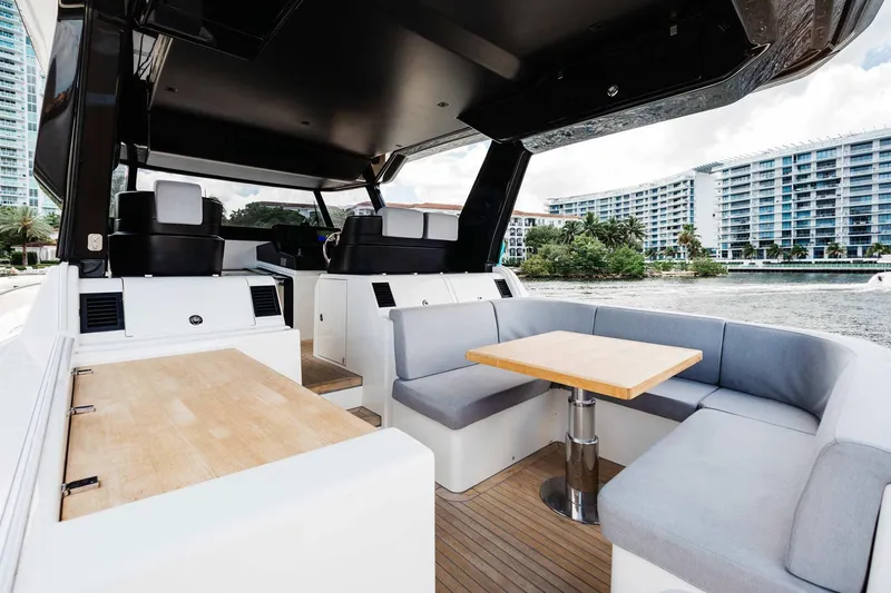 Slide: The Image of Interior of 2019 Bluegame BG62 yacht with modern seating and dining area. - 12