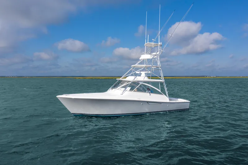 Slide: The Image of 2025 Viking 38 Open Billfish yacht on open water under blue sky. - 0