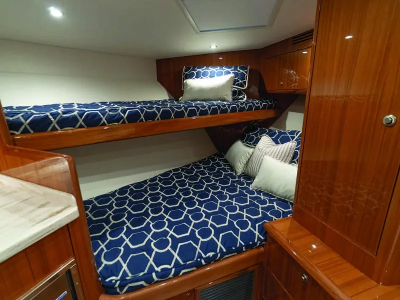 Slide: The Image of 2025 Viking 38 Open Billfish cabin with wooden interior and bunk beds. - 3
