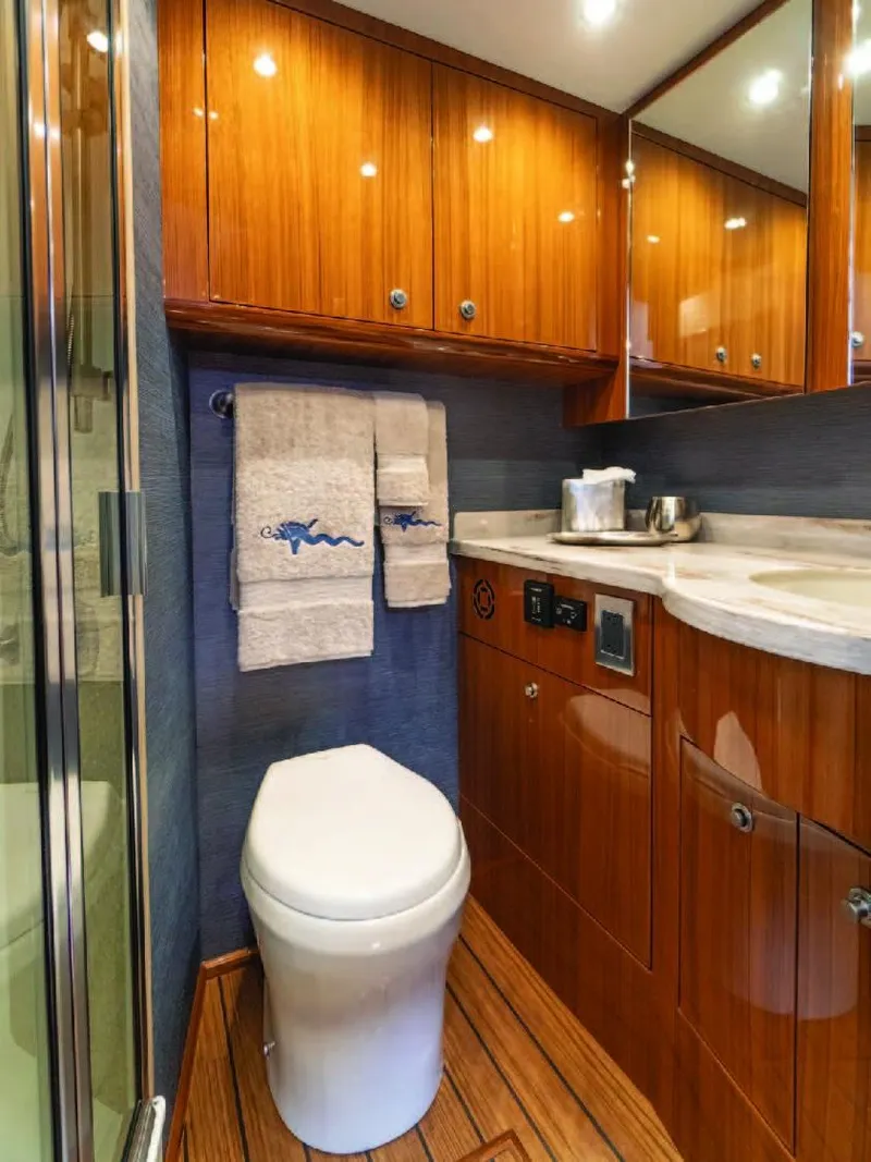 Slide: The Image of Luxurious bathroom in 2025 Viking 38 Open Billfish yacht with wooden cabinetry. - 4