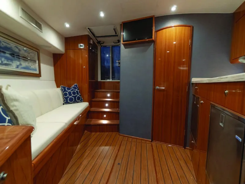 Slide: The Image of Interior of 2025 Viking 38 Open Billfish yacht with wooden flooring and modern amenities. - 5