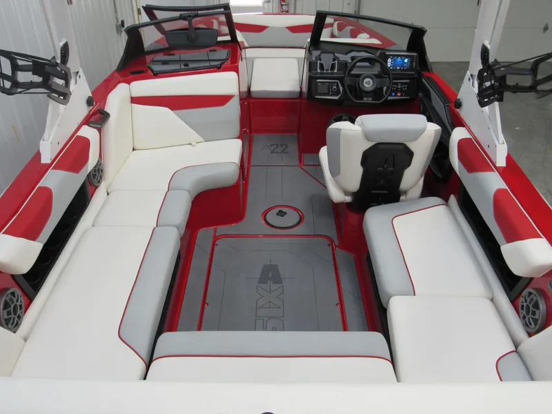 Slide: The Image of 2022 Axis A22 boat interior with red and white seating, modern dashboard, and spacious layout. - 4