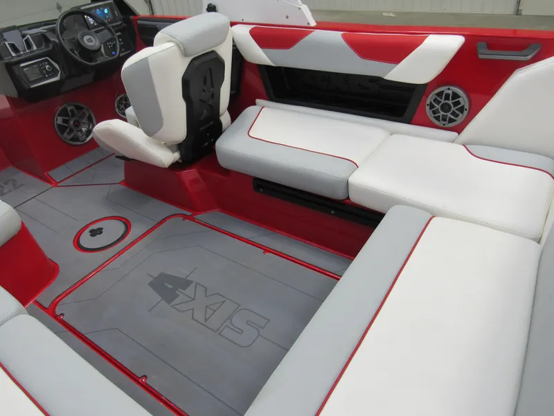 Slide: The Image of 2022 Axis A22 boat interior with red and white seating, steering wheel, and speakers. - 5