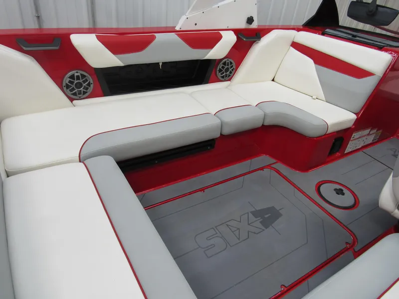 Slide: The Image of 2022 Axis A22 boat interior with red and white seating and integrated speakers. - 6