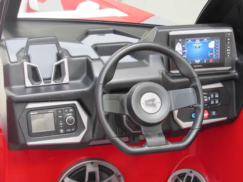 Slide: The Image of 2022 Axis A22 boat dashboard with steering wheel, touchscreen display, and control panel. - 7