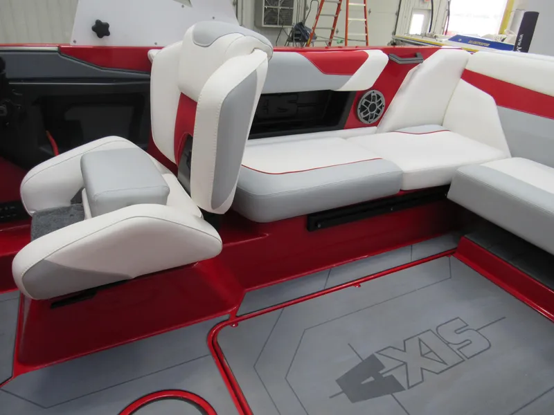Slide: The Image of 2022 Axis A22 boat interior with red and white seating and gray flooring. - 9