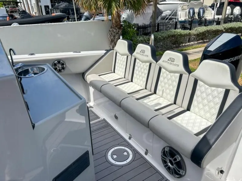 Slide: The Image of Luxury seating area on AMP Arth 333 boat, 2023 model, with diamond-stitched upholstery and modern amenities. - 16