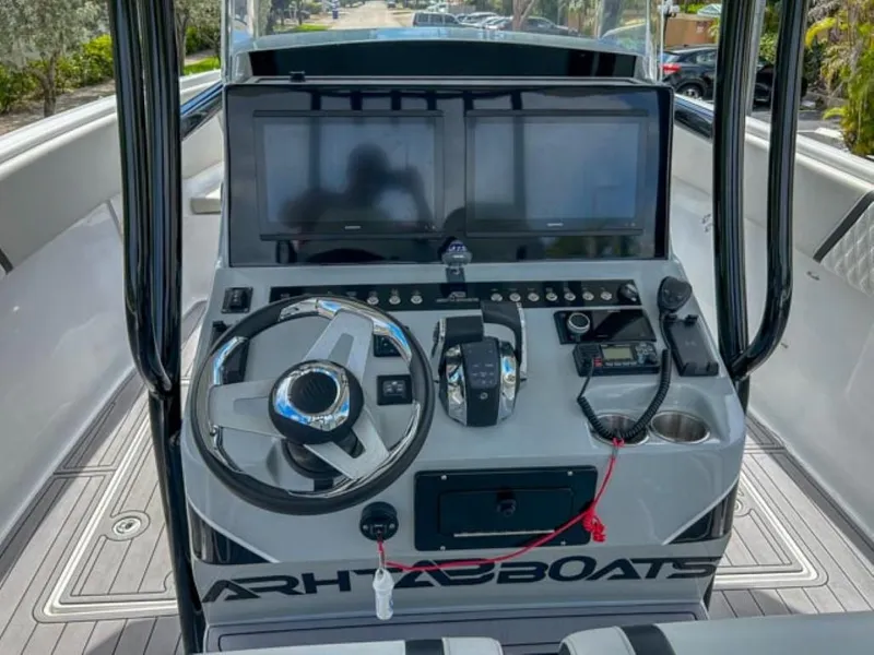 Slide: The Image of Control console of AMP Arth 333 boat, featuring dual screens and modern navigation equipment. - 8