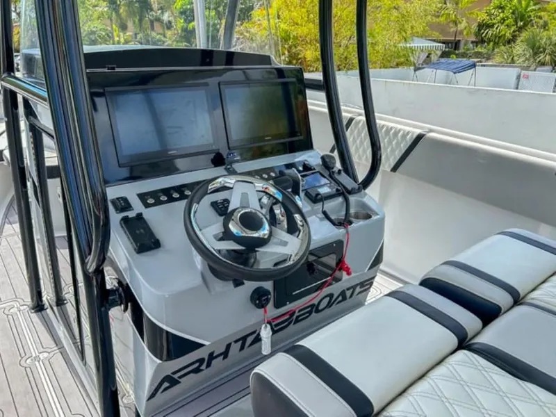 Slide: The Image of Control console of AMP Arth 333 boat, 2023 model, featuring dual screens and modern steering. - 9