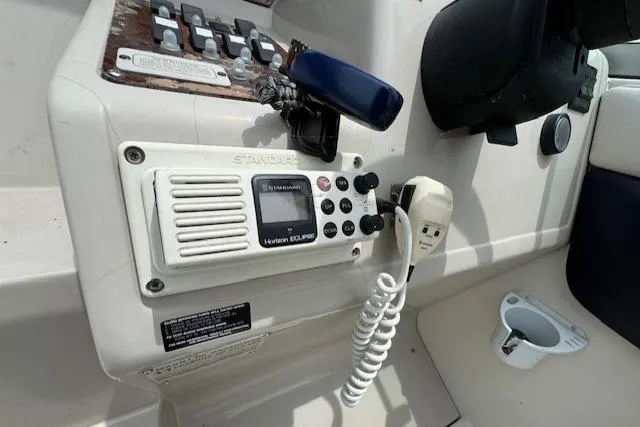 Slide: The Image of Control panel of a 1995 Regal 256 Commodore boat with radio and switches. - 14