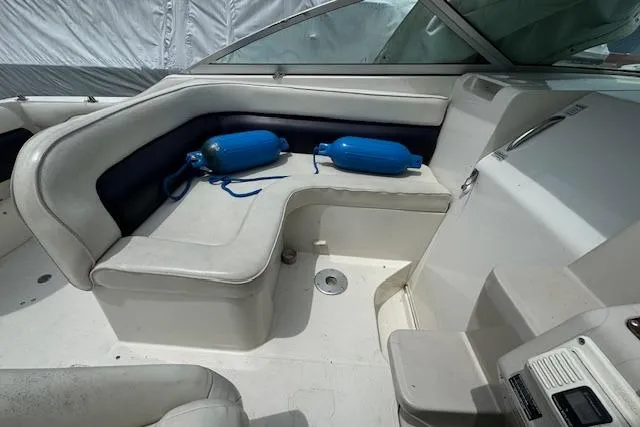 Slide: The Image of Interior seating area of a 1995 Regal 256 Commodore boat with blue fenders. - 2