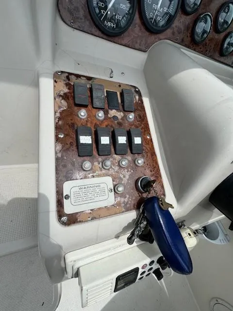 Slide: The Image of Control panel of a 1995 Regal 256 Commodore boat with switches and gauges. - 20