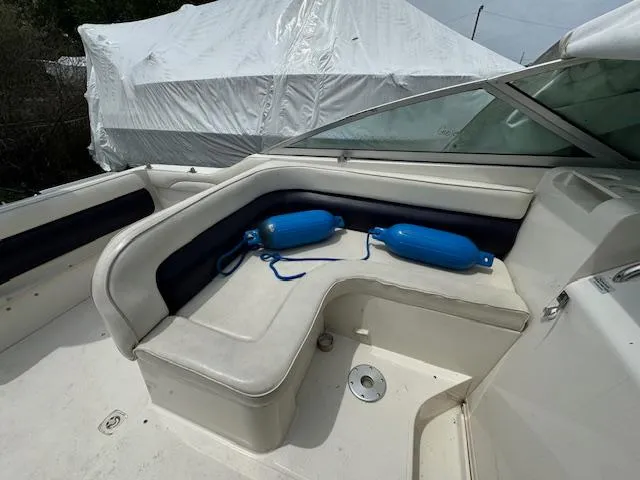 Slide: The Image of 1995 Regal 256 Commodore boat interior with seating and blue fenders. - 21