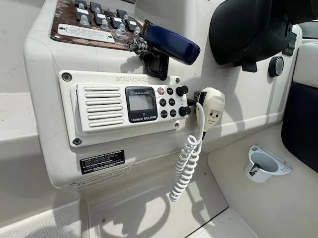 Slide: The Image of 1995 Regal 256 Commodore boat control panel with Standard Horizon Eclipse radio. - 24