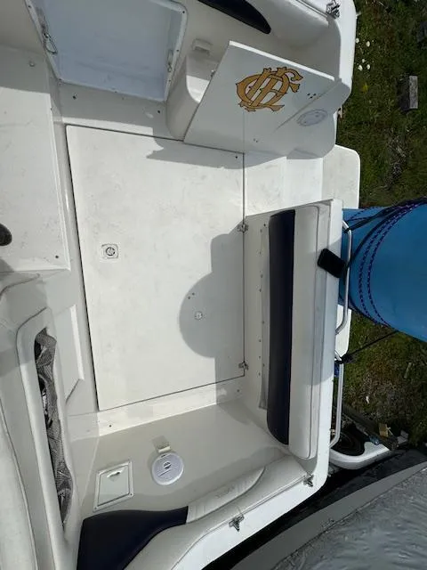 Slide: The Image of 1995 Regal 256 Commodore boat interior with white and navy seating. - 26