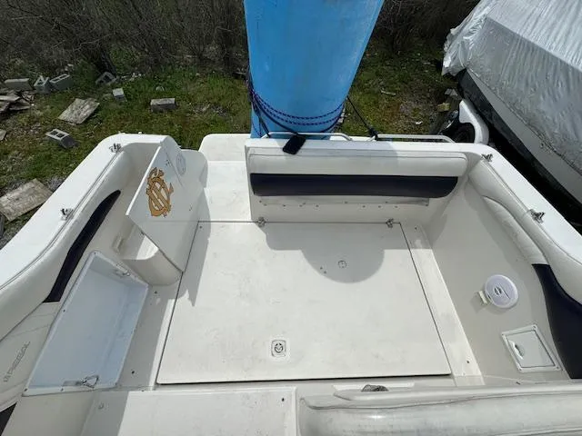 Slide: The Image of 1995 Regal 256 Commodore boat deck with seating and storage compartments. - 29