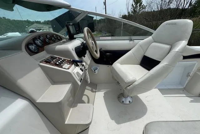 Slide: The Image of 1995 Regal 256 Commodore boat cockpit with steering wheel and control panel. - 3