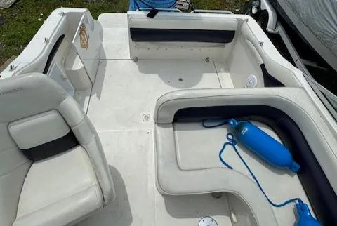 Slide: The Image of 1995 Regal 256 Commodore boat interior with white and navy seating. - 33